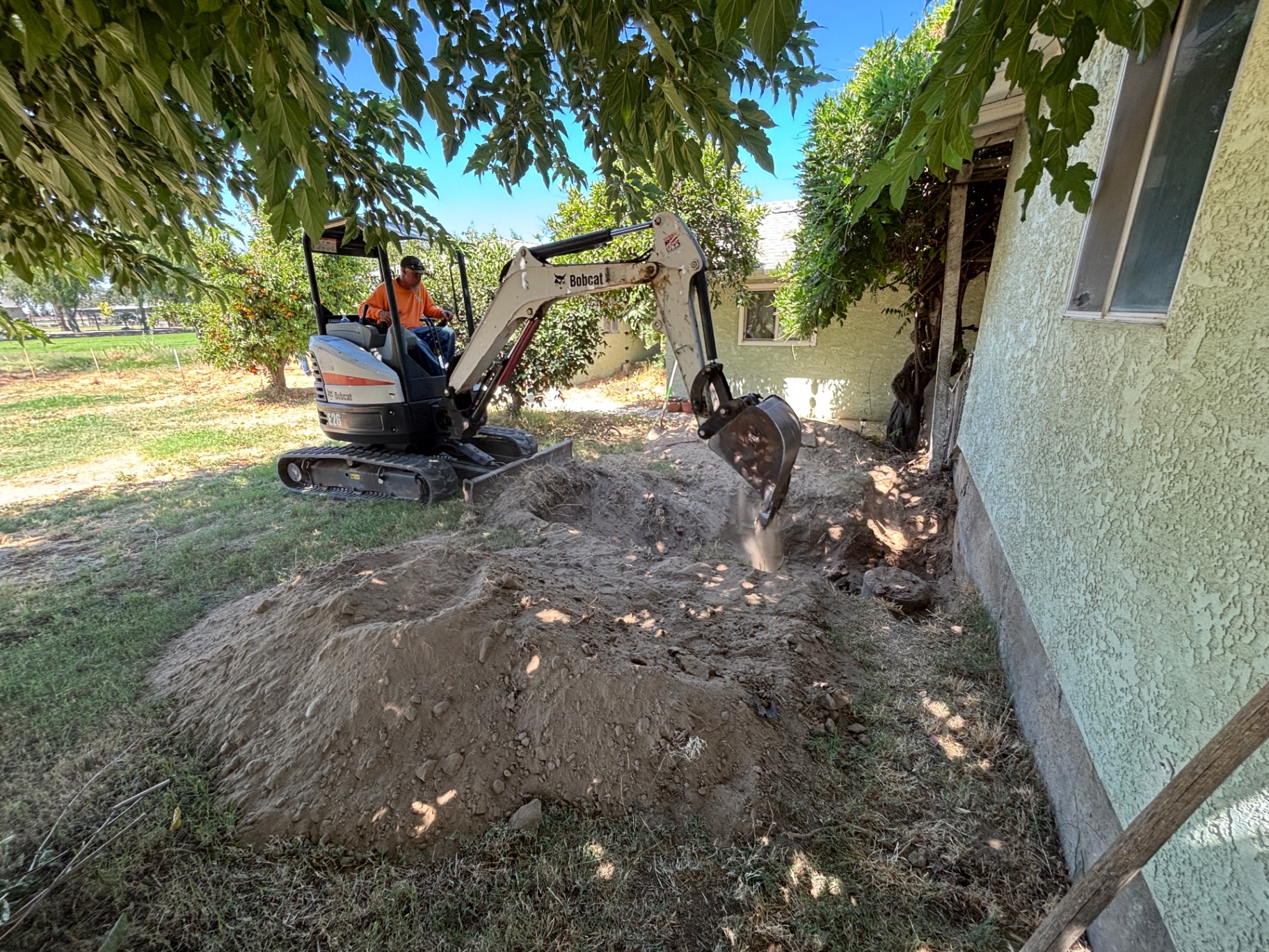 House-side trenching with mini excavator