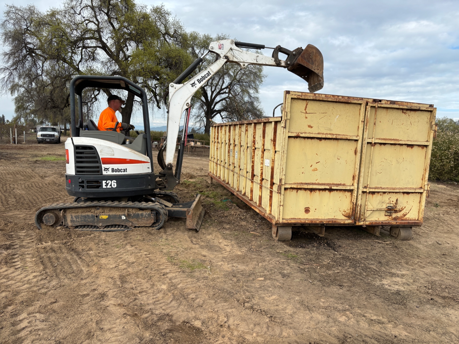 Mini excavator loading spoils
